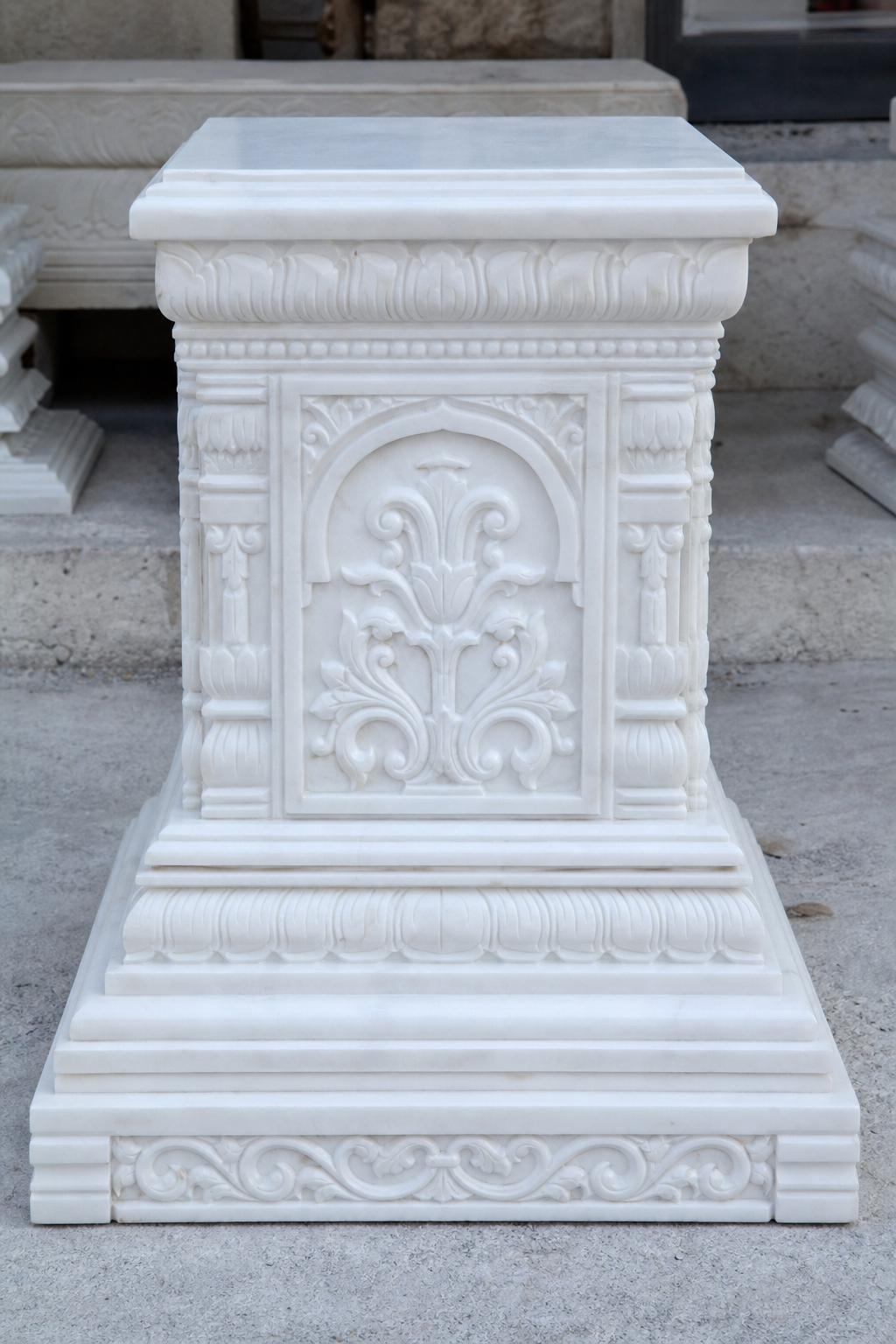 Marble murti craftsmanship showing hand-carved pedestal detailing by Damiani Art artisans