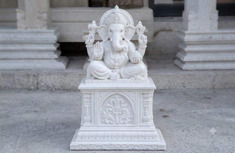Marble murti craftsmanship showing hand-carved pedestal detailing by Damiani Art artisans